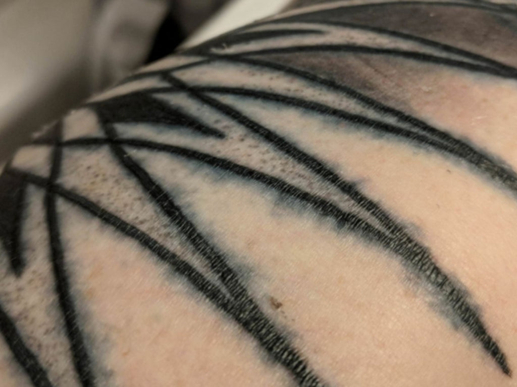 Tattoo showing the signs of tattoo blowout.